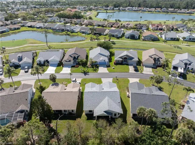 Drone / aerial view with a residential view and a water view