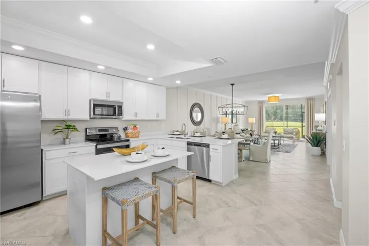 Kitchen with a peninsula, visible vents, a sink, stainless steel appliances, and open floor plan