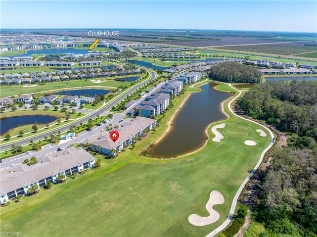 Aerial view with golf course view and a water view