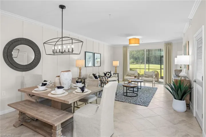 Dining area featuring a chandelier, crown molding, light tile patterned flooring, and baseboards