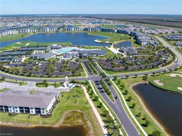 Drone / aerial view with a residential view, a water view, and view of golf course