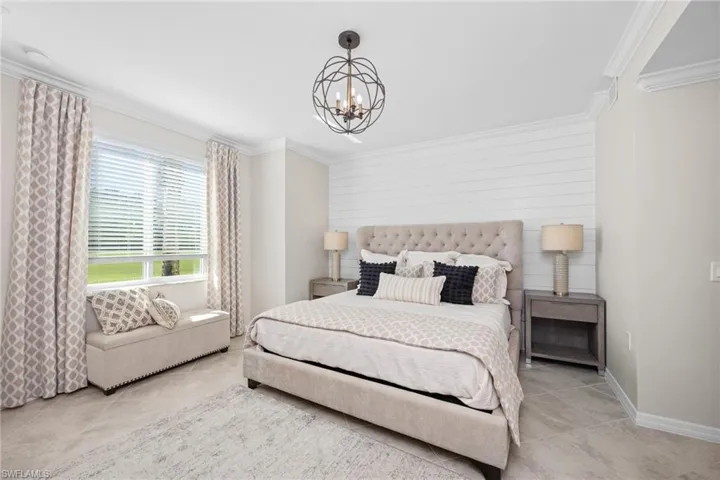 Bedroom featuring light tile patterned floors, a notable chandelier, ornamental molding, and baseboards
