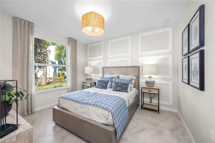 Bedroom with light tile patterned floors and baseboards