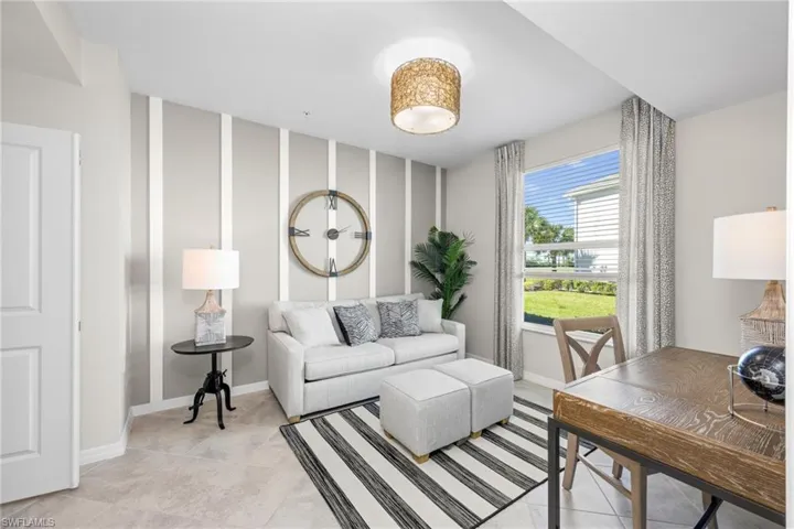 Living area featuring light tile patterned floors and baseboards