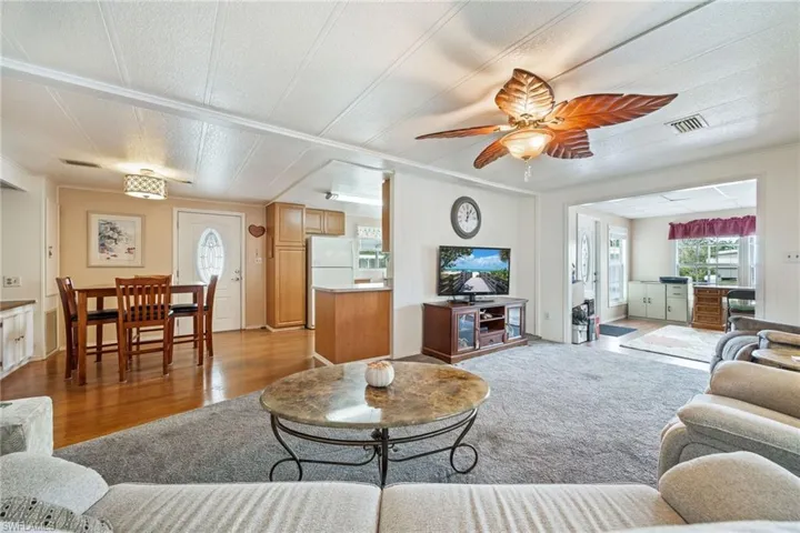 Living room featuring light wood finished floors and a ceiling fan