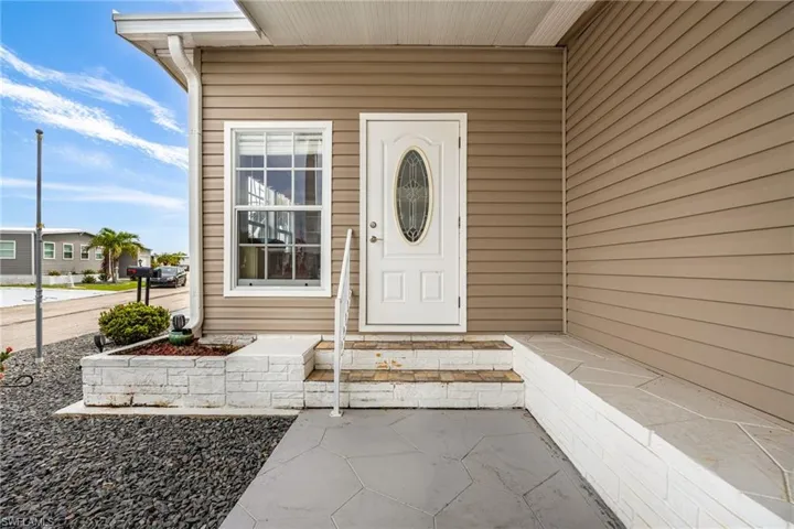 Property entrance with covered porch