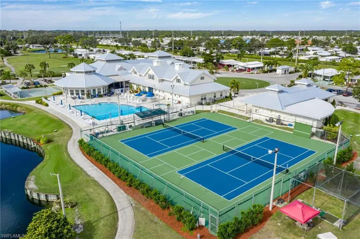 Aerial view of a pool area and a large body of water