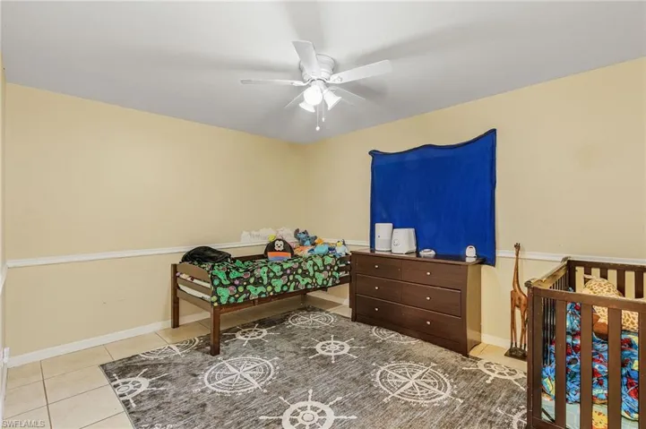 Bedroom featuring ceiling fan and light tile patterned floors