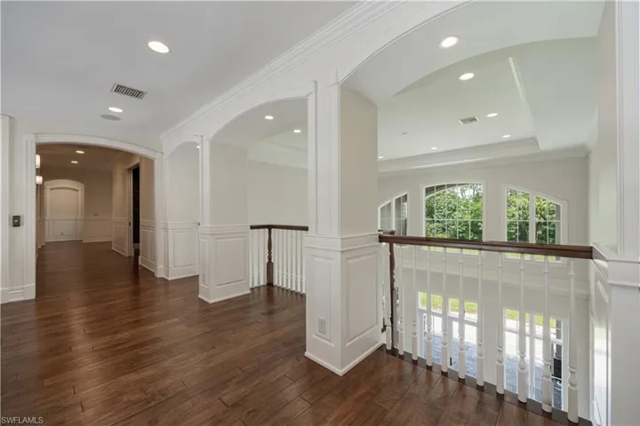 Upstairs Hallway overlooking Grand Foyer with Wood Flooring