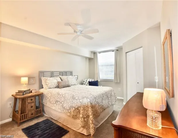 Bedroom featuring carpet floors, a ceiling fan, and a closet