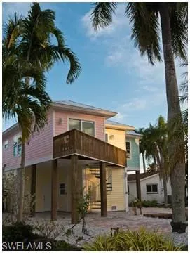 Rear view of property featuring a patio area, a deck, and stairs