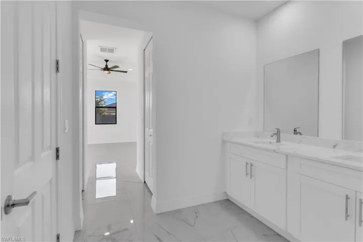 Bathroom with ceiling fan and vanity
