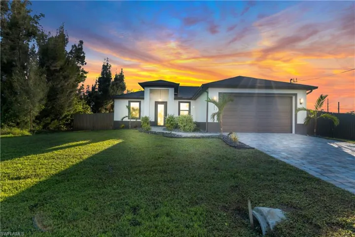 Modern home featuring a garage and a yard