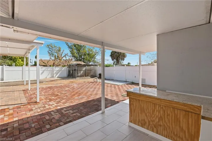 Fenced backyard with a patio