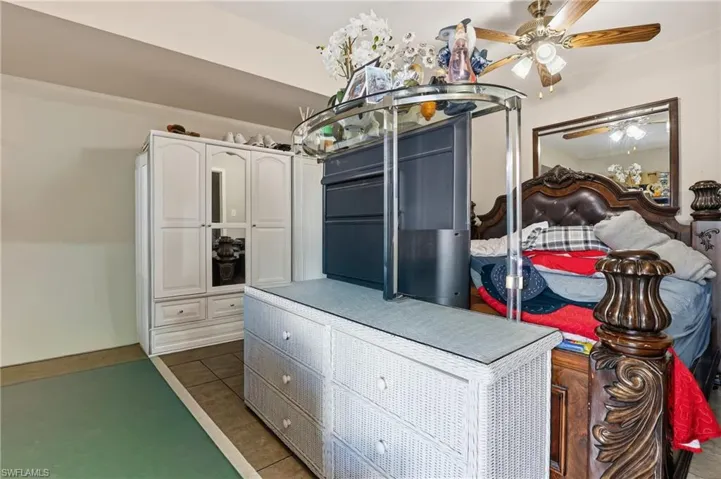 Walk in closet with ceiling fan and light tile patterned floors