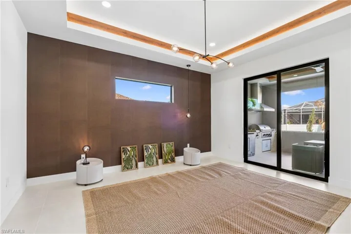 Living space featuring a textured accent wall, recessed lighting, and wood-finish ceiling details