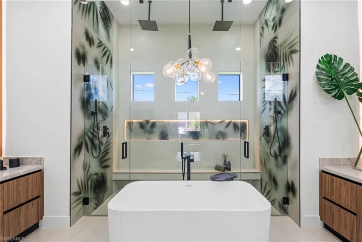 Freestanding soaking tub with a fluted exterior, positioned centrally in this bathroom