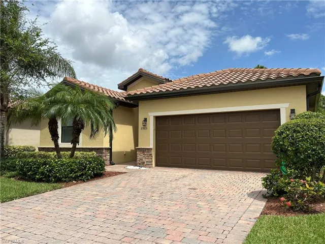 Mediterranean / spanish home with stucco siding, stone siding, decorative driveway, a garage, and a tile roof