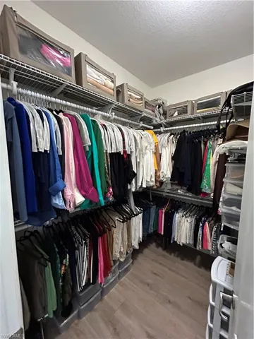 Walk in closet featuring light wood-style flooring