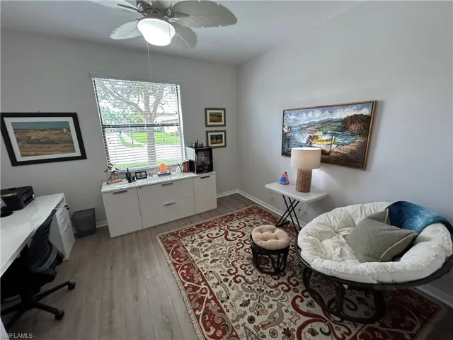 Office space with light wood-type flooring and ceiling fan