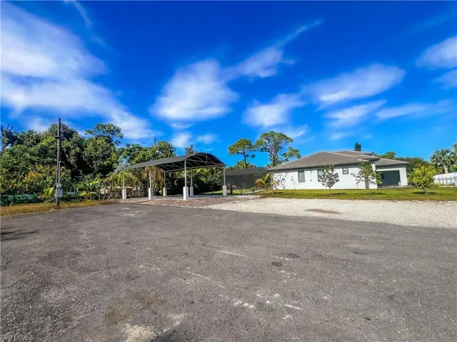 View of front of home featuring a carport and driveway