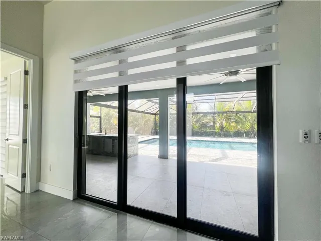 Entryway with a sunroom and baseboards