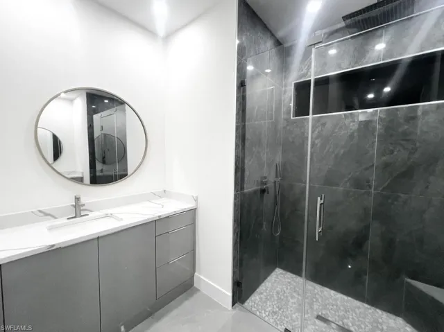 Bathroom featuring vanity and a shower stall