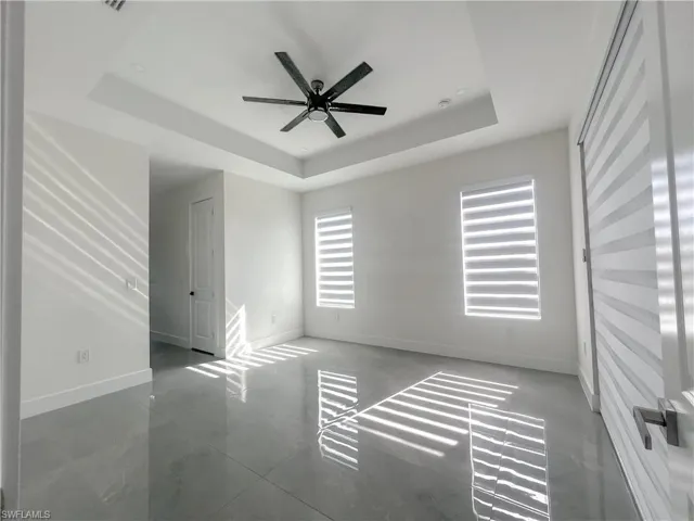 Spare room featuring baseboards and ceiling fan