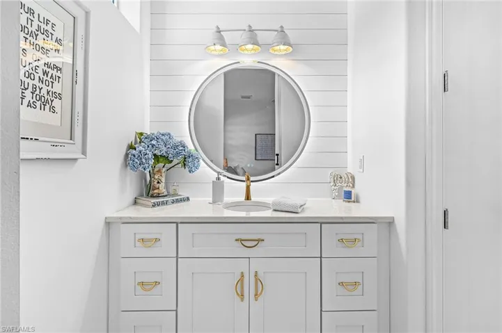 Bathroom featuring vanity and wooden walls