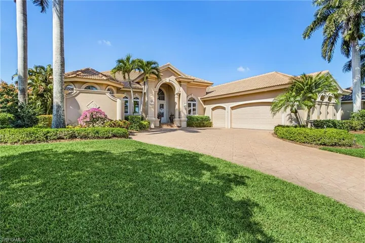 Mediterranean / spanish home with stucco siding, driveway, a tile roof, a garage, and a front yard
