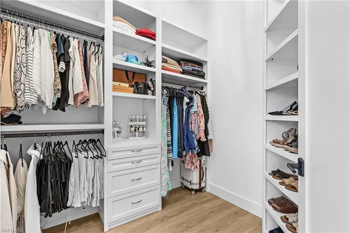 Walk in closet featuring light wood-type flooring