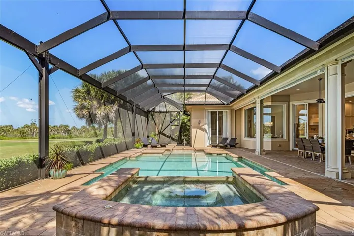 Integrated pool / spa featuring a sunroom, a patio, and glass enclosure