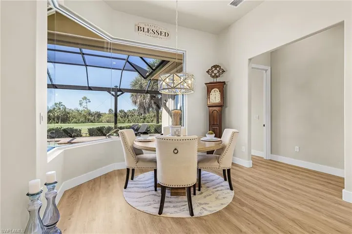 Dining room featuring a sunroom and light wood finished floors