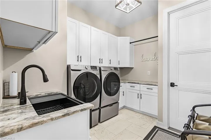 Laundry room with cabinet space and separate washer and dryer