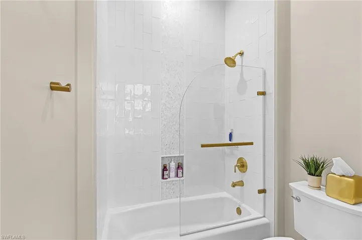 Bathroom featuring toilet and shower / bath combination