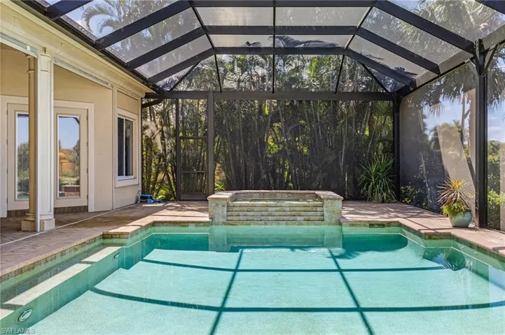 Integrated pool / hot tub with a patio, a lanai, and a sunroom