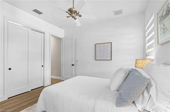 Bedroom featuring wood finished floors, ceiling fan, and a closet
