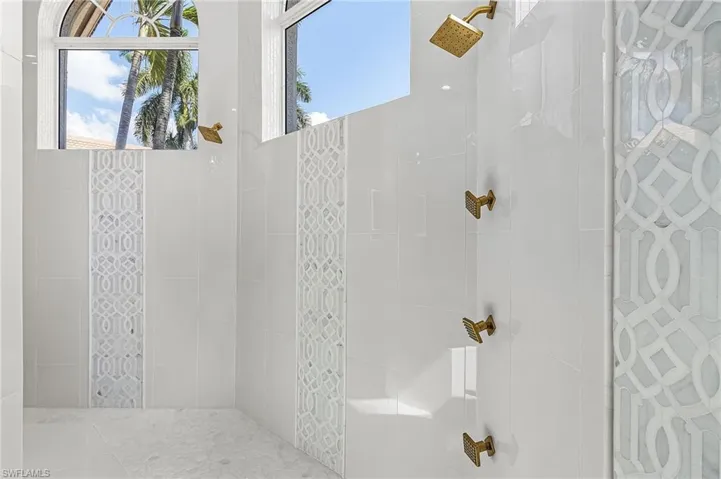 Primary Bathroom featuring tiled shower