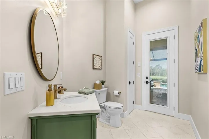 Pool half bathroom with vanity and light tile patterned floors