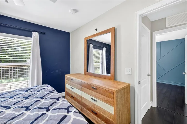 Bedroom with dark wood-type flooring and ceiling fan