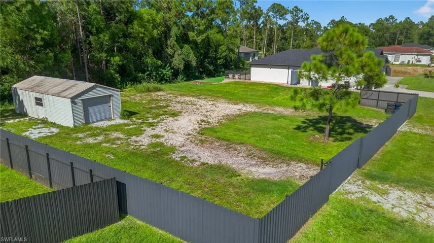 View of yard with a garage and an outdoor structure