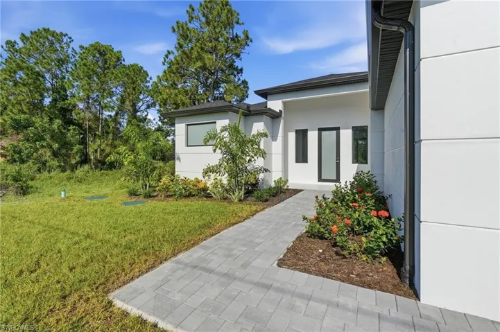 Smooth-textured exterior with a contemporary black-framed entry door
