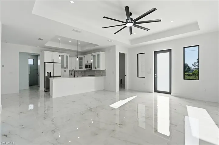 Kitchen with white cabinetry, stainless steel appliances, and a breakfast bar