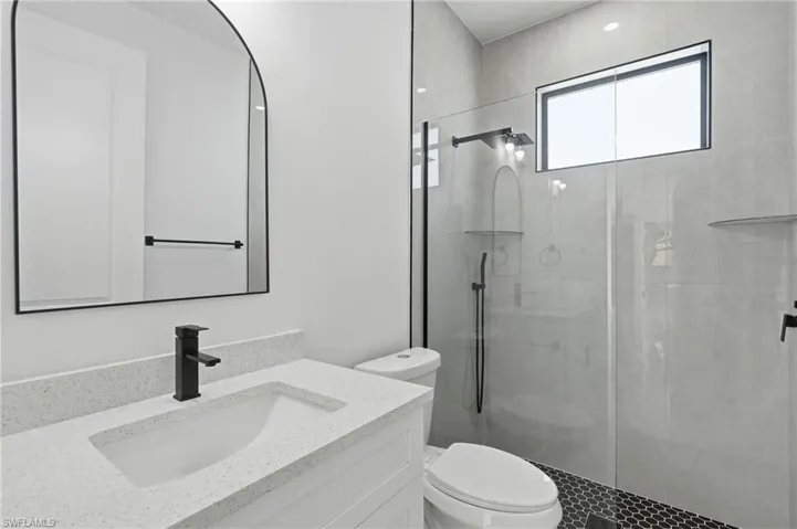 Modern vanity with integrated sink and matte black faucet