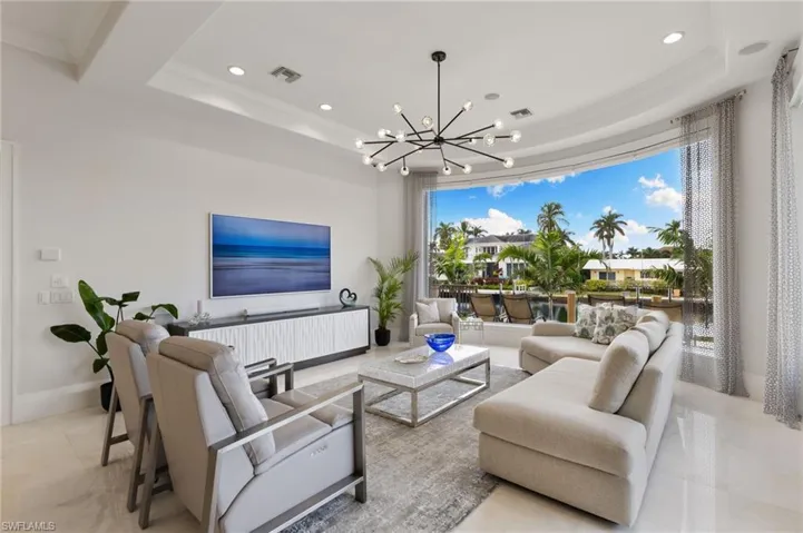 Living room with water views through frameless glass