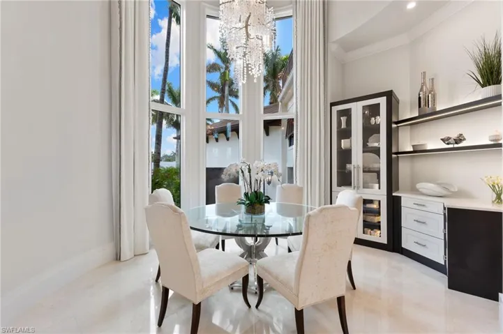 Dining space featuring high ceilings and built-in cabinets