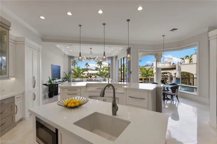 Kitchen featuring double islands and a great pool and water view