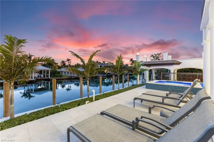 Pool at dusk with water view