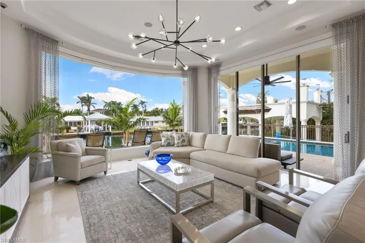 Living room with water views through frameless glass