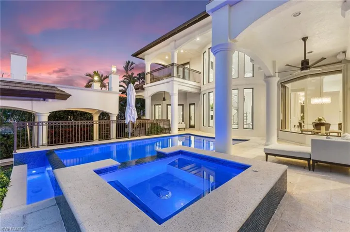 Pool at dusk with overflow hot tub